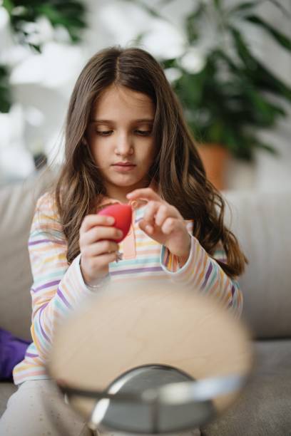 istock A little girl is playing with makeup 1389497425