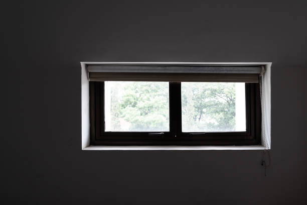 istock Small Window on the Dark Bedroom 1389497475
