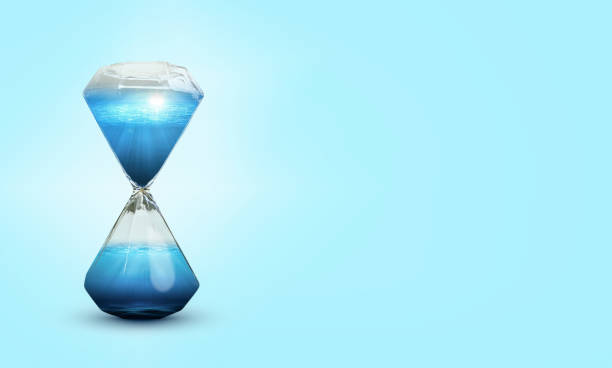 istock Hourglass with water on blue background. 1389501874