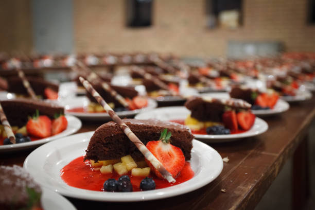 Close-up of chocolate brownies with fruits served in plates stock photo