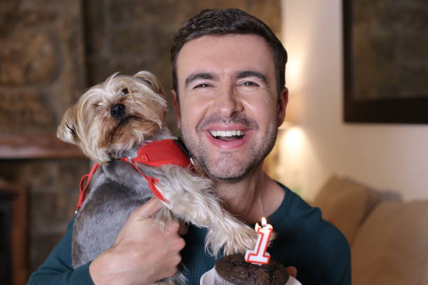 Man celebrating his dog´s birthday.