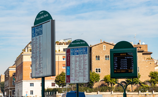Rome, Italy - March 4, 2022: A picture of multiple timetables and display of a bus stop in Rome.
