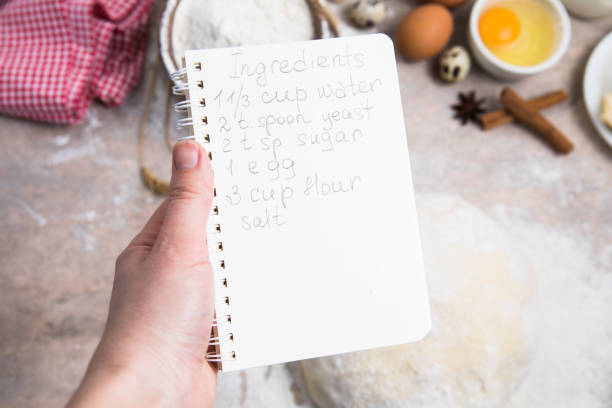 istock blank notebook for recipes in child hands. 1389508541