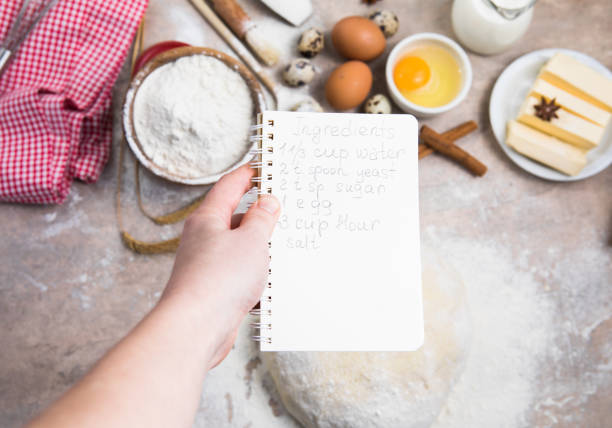 blank notebook for recipes in child hands.