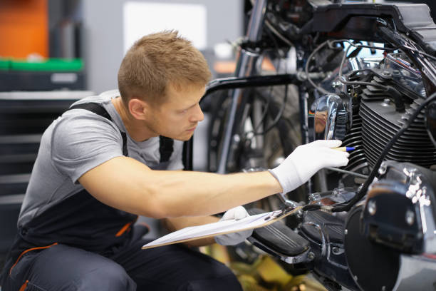 istock A mechanic sits in a workshop near a motorcycle 1389508691
