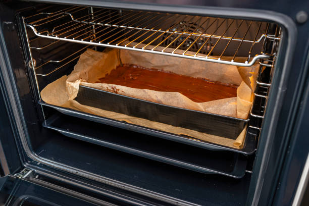 istock Baking tray with raw dough in the oven ready for baking. 1389509899