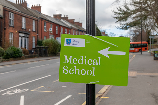 Sheffield, South Yorkshire, United Kingdom - March 5 2022: A sign outside the Royal Hallamshire Hospital in Sheffield, pointing to the University of Sheffield's Medical School.