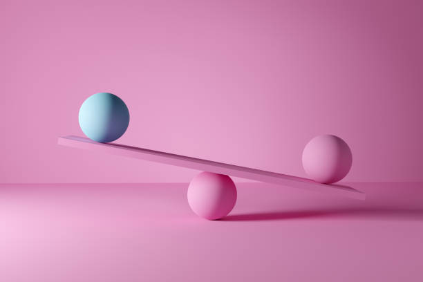 синие и розовые шары несбалансированы на шкале. нестабильность, неравенство, несправедливость или неравенство - balance seesaw weight sphere стоковые фото и изображения