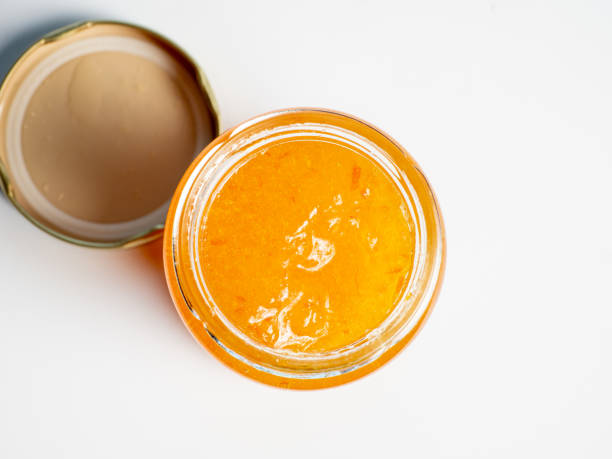 istock open jar and lid with orange marmalade jam inside on a white background 1389514122