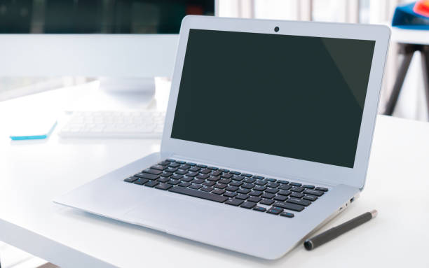 istock Blank Screen Laptop Computer Mock up on office desk for application website template advertisement. 1389514589