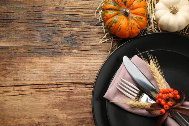 istock Festive table setting with pumpkins and space for text on wooden background, flat lay. Thanksgiving Day celebration 1389515135