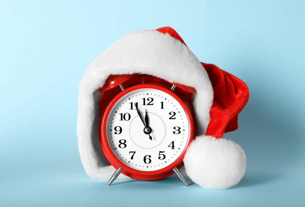 istock Alarm clock with Christmas decor on light blue background. New Year countdown 1389516328