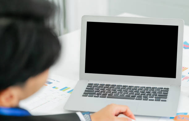istock Asian Businessman sitting in front a blank screen laptop computer for mock up and template. 1389516613