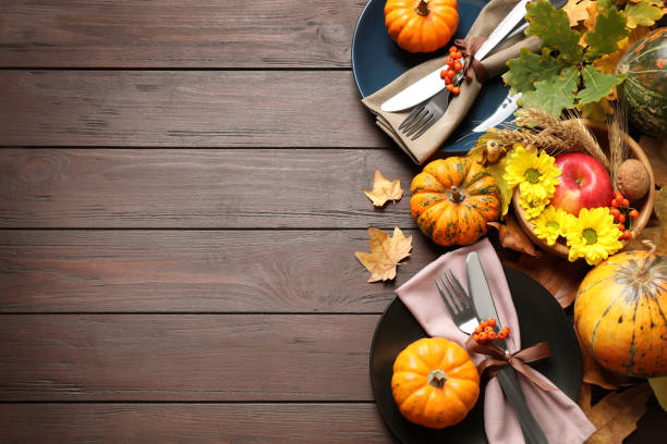 istock Festive table setting on wooden background, flat lay with space for text. Thanksgiving Day celebration 1389516823