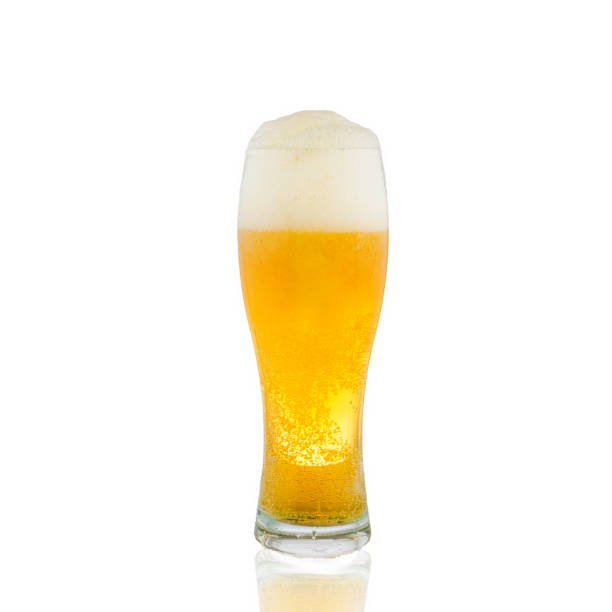 istock light beer in a glass glass with thick white foam. white background. 1389516840