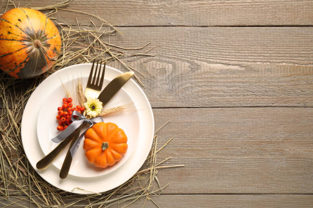 istock Festive table setting on wooden background, flat lay with space for text. Thanksgiving Day celebration 1389517820