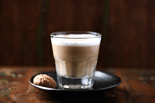 Coffee with milk on dark wooden background. Soft focus. Close up. Copy space.