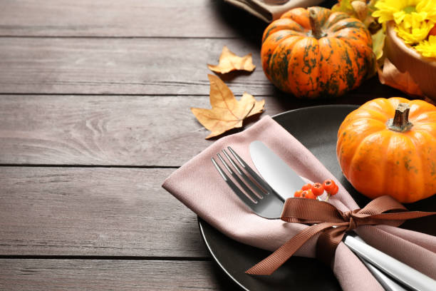 istock Festive table setting with autumn decor and space for text on wooden background, closeup. Thanksgiving Day celebration 1389517965