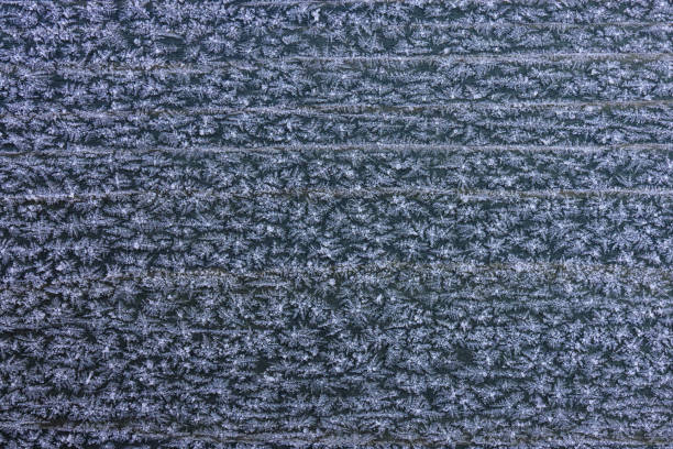 istock Frozen pattern and snowflakes on wooden pattern. Color high resolution texture photo for backgrounds. 1389518506