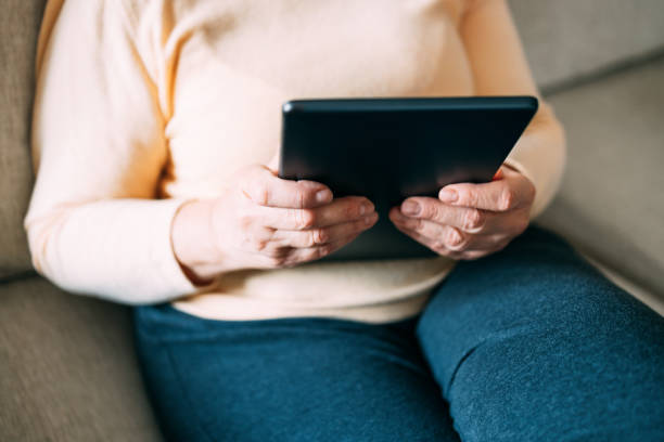 istock Old woman hands using a tablet. Old people with technology concept 1389523072