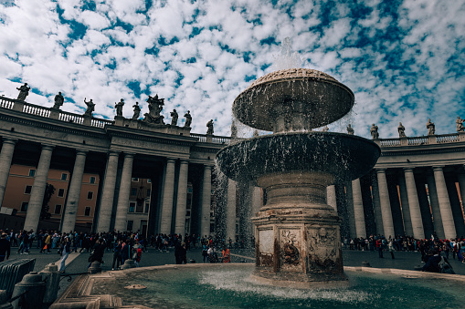 Rome, Italy, Europe - May 3, 2019: Beautiful city landscape of Roman culture. Clear sky and white clouds. People are walking around architecture.