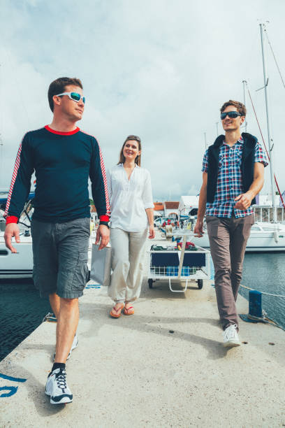 istock Young couple arriving to marina for sailing 1389524832