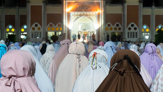 Muslim women Ramadan night praying out door of mosque