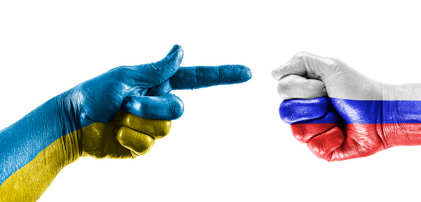 Blue yellow hand pointing a white blue red  fist on white background.
