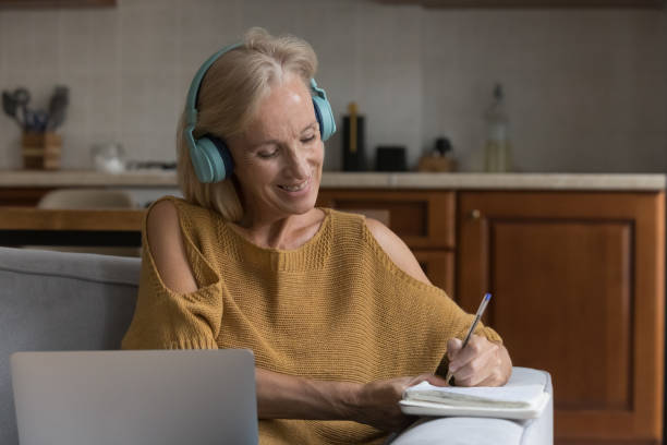 istock Happy senior 50s online course student woman watching learning webinar 1389527316