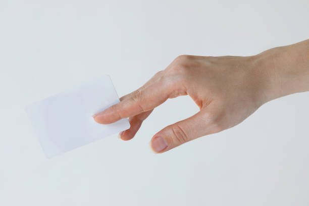 Close-up of a card in a woman's hand isolated on white.