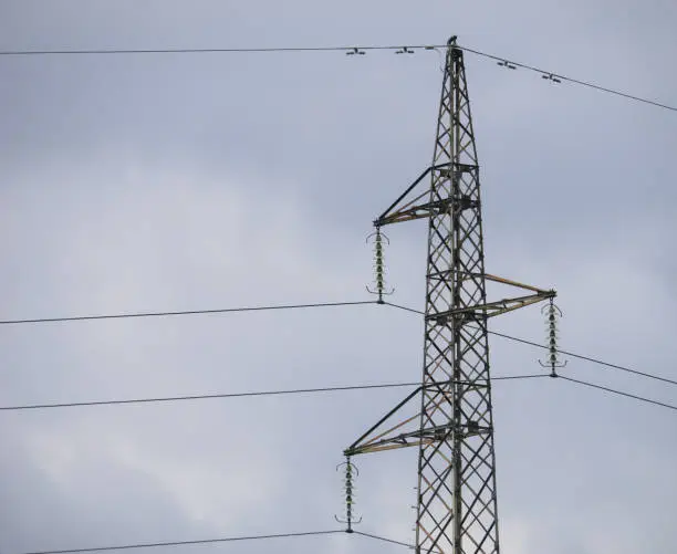 Closeup of a dead-end tower or anchor pylon with the sky in the background