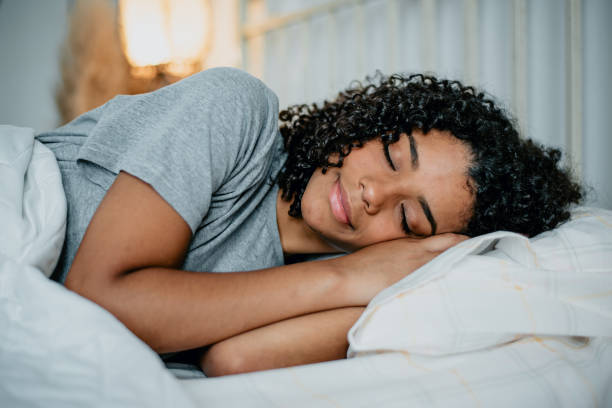 teenager sleeping in bed - woman sleeping imagens e fotografias de stock