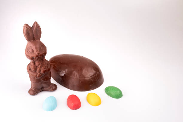 istock chocolate easter bunny, chocolate egg and colorful eggs seen from above isolated on white background 1389534687