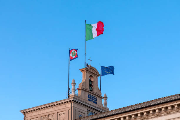 Rome, Italy - February 28, 2022: Quirinale, the bell tower with the clock and the waving flags. Institutional seat of the President of the Italian Republic.\