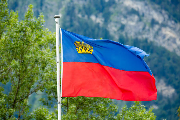 istock Liechtenstein flag waving on mountain background 1389537219