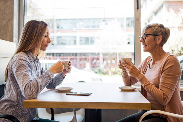 istock Mother and daughter  having coffee in cafe 1389538853