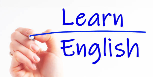 istock hand with pen is writing the text Learn English on the transparent whiteboard 1389541445