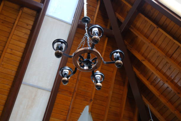 Low angle chandelier, chandelier inside a small mosque made of wooden material.