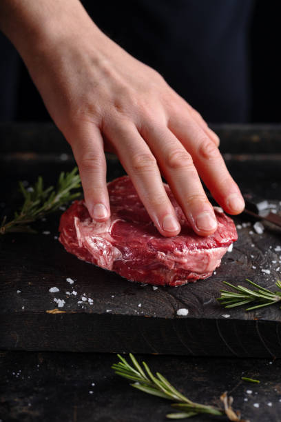 istock Cook cooking fresh meat on board 1389542640