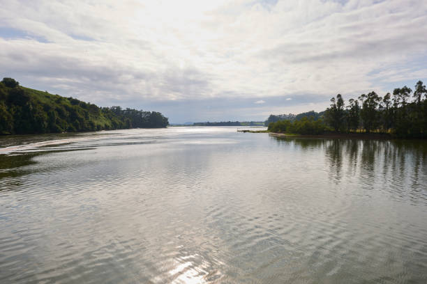 istock A river with vegetation along its banks under a cloudy sky 1389543367