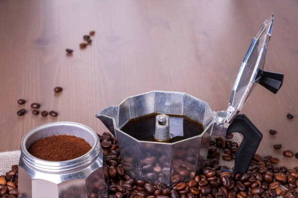 istock Disassembled geyser coffee maker on wooden surface. Coffee beans. 1389546293