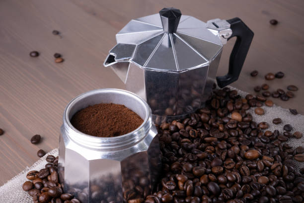 istock Disassembled geyser coffee maker on wooden surface. Coffee beans. 1389546332
