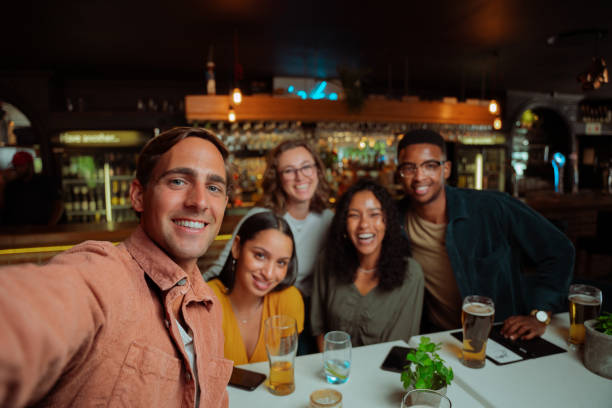istock diverse group of friends going out for dinner taking selfie 1389546691