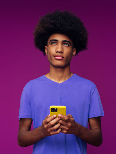 istock Portrait of funny afro guy using phone 1389547343