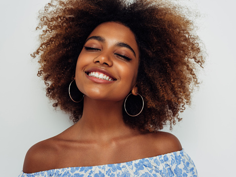 Beautiful smiling girl with curly hairstyle