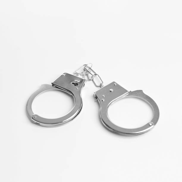 istock Police handcuffs on isolation closeup 1389547962