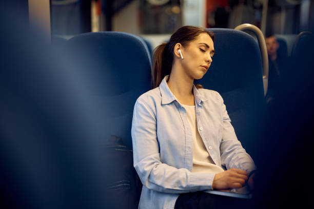 istock Young woman taking a nap while commuting by train. 1389548490