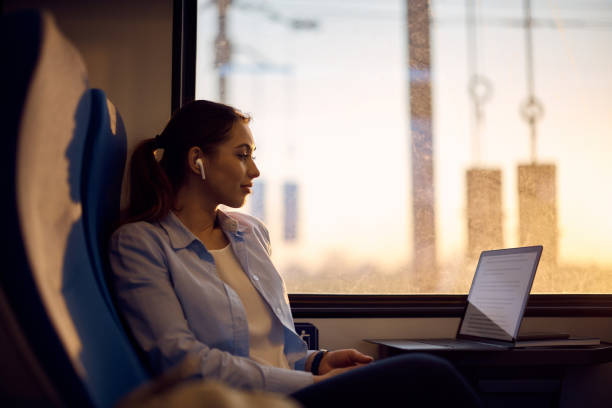 istock Young woman e-learning on laptop while traveling by train. 1389549259