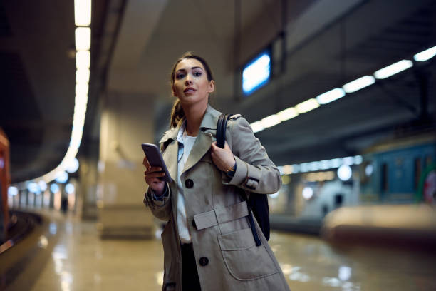 istock Young woman waiting for the train at subway. 1389549474