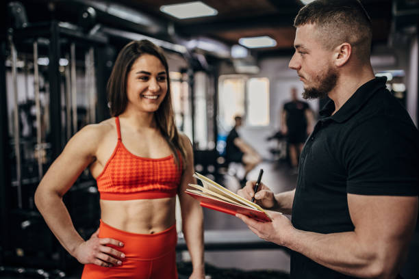 istock Fit woman with personal trainer 1389549623